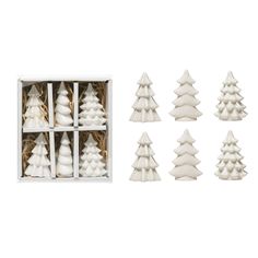 twelve white ceramic christmas trees in a box