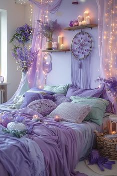 a bed covered in purple sheets and pillows next to a window with lights on it