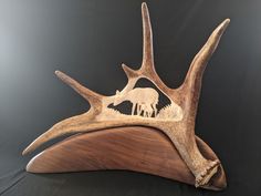 the antler is carved to look like it has an animal's head on it