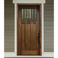 a wooden door on the side of a house