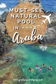 people swimming in the water with text overlay that reads must - see natural pool in aruba