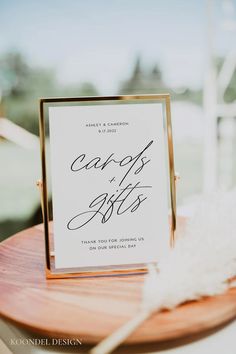 a table with a sign that says god and faith on it, next to a white feather