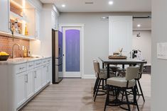 Basement remodel, with full bathroom that includes a sauna, a full workout room, office space, full wet bar with wine cooler storage, and a basement kitchenette