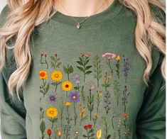 Pressed Flowers Long Sleeve Tshirt with a boho, wildflower, and cottagecore design. This vintage botanical tee, featuring pastel floral prints, is a perfect gift for nature lovers. It gives a whimsical and natural vibe, fitting seamlessly into a bohemian or cottagecore aesthetic. Ideal for those who appreciate the beauty of wildflowers and vintage botanical art. Relevant for spring celebrations, nature enthusiasts, and boho style lovers. Custom to Oder in USA. 100% Satisfaction Guarantee. No question asked. HIGHT - QUALITY MATERIAL Custom Color Shirt, Sweatshirt, Hoodie, Super soft cotton and excellent quality print makes. Runs true to size For T-shirt Sizes Please refer to the Listing Image. CARE INSTRUCTION: Machine wash: warm (max 40C or 105F): Non-chorine: bleach as needed; Tumble dry: Vintage Sleeves, Cottagecore Design, Pastel Botanical, Cottagecore Gifts, Boho Wildflower, Spring Celebration, Sustainable Style, Cottagecore Aesthetic, Pastel Floral