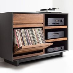 an old record player is sitting on top of a cabinet