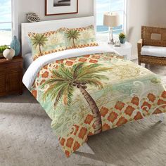 a bed room with a neatly made bed and palm trees on the comforter set