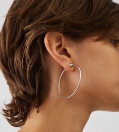 The Icon Hoops are re-engineered to be more functional and elevated than ever. Consider these your wear-with-everything piece; a classic hoop shape that never goes out of style. The 360 degree full circle design means the earrings won't catch your hair. The flexible stainless steel material is water-durable and one third of an inch thicker than the previous design. An easy-to-use tension closure to ensure the Icon Hoops will stay put and you won't have to search for an earring backing. Finished in high-polish rhodium. inish: high polishrhodium ion plated steeltension closure product measurements:length: 57mm / 2.24"width: 55mm / 2.17"depth: 6.8mm / 0.27"wire thickness: 2mm / 0.08"weight: 3.25g / 0.113oz Jenny Bird, Media Icon, Virtual Fashion, Bag Icon, Polish Silver, Gold Dipped, Circle Design, Full Circle, Stainless Steel Material