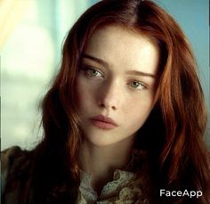 a woman with red hair and green eyes