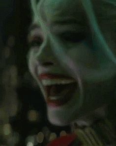 a close up of a person wearing a joker mask