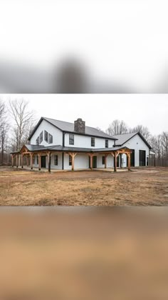 a large white house sitting in the middle of a field