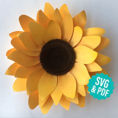 a large yellow sunflower sitting on top of a white table