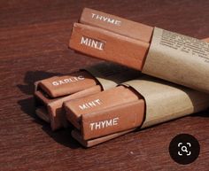 three tubes of lipstick sitting on top of a wooden table