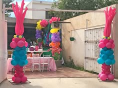 an outdoor party with balloons and decorations