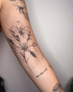 a woman's arm with flowers on it and the words i love you in cursive writing