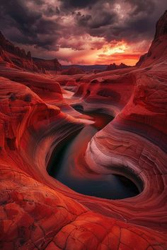 the sun is setting over some red rocks and water in the valley, which looks like it's going to be melted