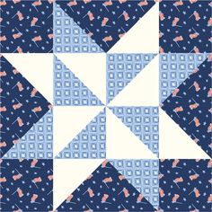 a blue and white patchwork quilt with an arrow in the center, on top of it