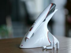 a white and red object sitting on top of a wooden table