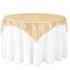 a gold and white table cloth on top of a round table with a satin edge