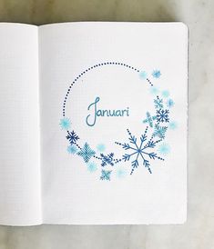 an open book with snowflakes and the word january written in blue on it