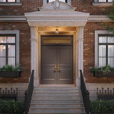 an entrance to a large brick building with two doors and steps leading up to it