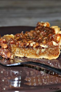 a piece of pecan pie on a plate with a fork