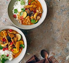 two bowls filled with food on top of a table