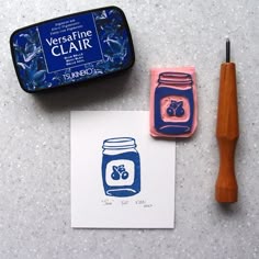 a rubber stamp with a mason jar on it next to a piece of paper and a pen