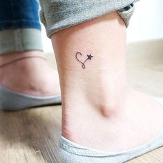 a small heart and star tattoo on the ankle