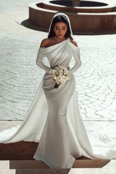 a woman in a wedding dress standing on steps