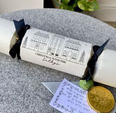 a roll of toilet paper sitting on top of a table next to a gold coin