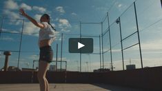 a woman standing on top of a tennis court with her racquet in the air