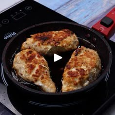 three pieces of chicken cooking in a skillet on top of an electric burner