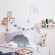 a child's bedroom with toys and decor on the wall