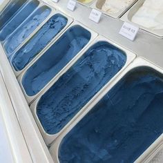 several trays of ice cream sitting on top of a counter