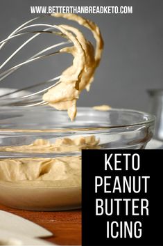 a whisk being used to make peanut butter icing in a glass bowl