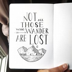 someone holding up a notebook with the words not all those who wander are lost