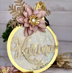 a gold and white christmas ornament sitting on top of snowflakes