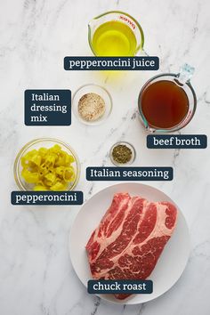 the ingredients to make an italian steak recipe on a white plate with marble counter top