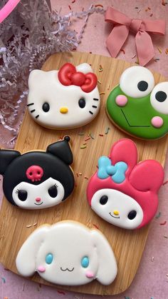 hello kitty cookies on a wooden board with sprinkles