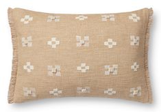 a tan pillow with white crosses on it