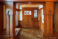 an entry way with wood paneling and stained glass windows