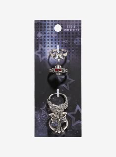 Look bad to the bone with these statement rings on! They feature shiny pieces with star designs  a skull with red gem eyes and a gothic cross ring.Size 7Nickel-free alloy; resinSet of 4Imported Gothic Star-shaped Party Jewelry, Hot Topic Ring Set, Gothic Metal Rings With Skull Print, Emo Rings, Goth Rings Hot Topic, Gothic Metal Rings For Streetwear, Social Collision, Gothic Metal Skull Ring, Gem Eyes