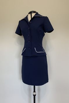 "Awesome vintage two piece top and skirt set in navy blue with white trim. Both pieces in excellent clean, like new, condition. Top has button down closure down front with short sleeves. Skirt is high waisted and shorter in length. Measurements (taken zipped or buttoned up and laid comfortably flat) x 2 for total circumference (inches) La Belle Made in USA *Top* Tag Size 7 Shoulder 15.5\"(seam to seam) Shoulder circumference up to 37\" Bust 36\" Waist 28\" Total Length 22\" Sleeve 7\" Top sleeve Blue Fitted Collared Set, Blue Collared Fitted Sets, Classic Fitted Short Sleeve Sets, Fitted Vintage Blue Set, Blue Fitted Vintage Set, Classic Navy Sets For Workwear, Classic Navy Sets For Work, Classic Navy Workwear Sets, Retro Fitted Blue Sets