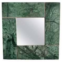 a square mirror with green marble on it