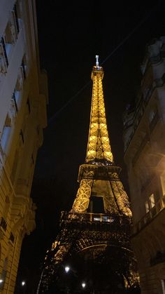 the eiffel tower is lit up at night