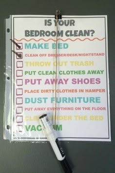 a bathroom cleaning checklist hanging on the wall with a toothbrush in front of it