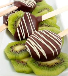 chocolate covered kiwis are sitting on skewers