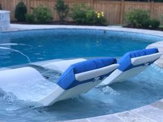 an inflatable chair sitting on the edge of a swimming pool