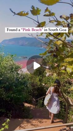 a woman walking up some steps towards the ocean with an umbrella in her hand and text that reads, found a pink beach in south goa