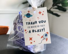 a thank you for making my party a blast card in a plastic bag on a table